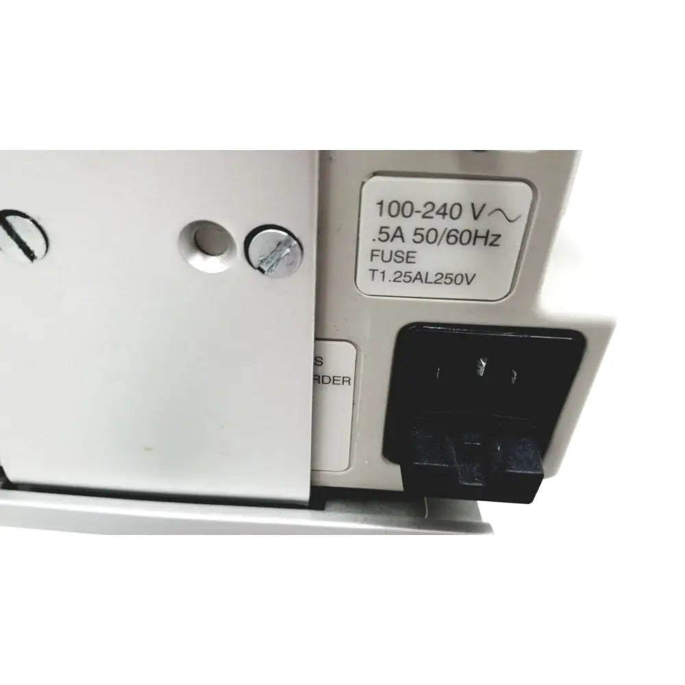 White electrical outlet with black plug labeled 100-240 v connected to casmed 740 patient monitor spo2 back side