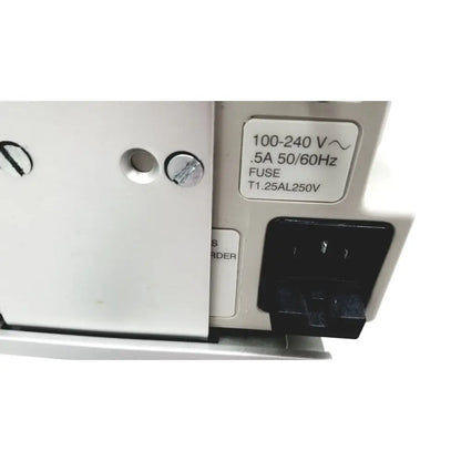 White electrical outlet with black plug labeled 100-240 v connected to casmed 740 patient monitor spo2 back side