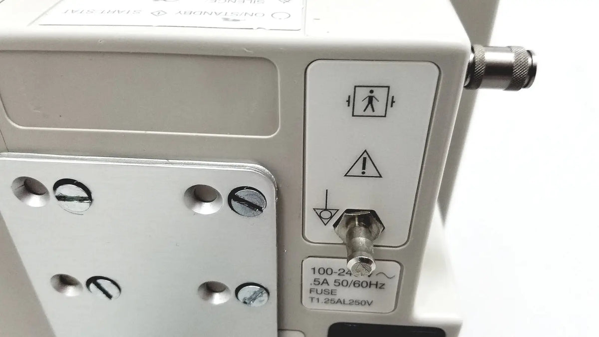 White casmed 740 patient monitor spo2 with metallic fuse and warning symbols on panel for medical use