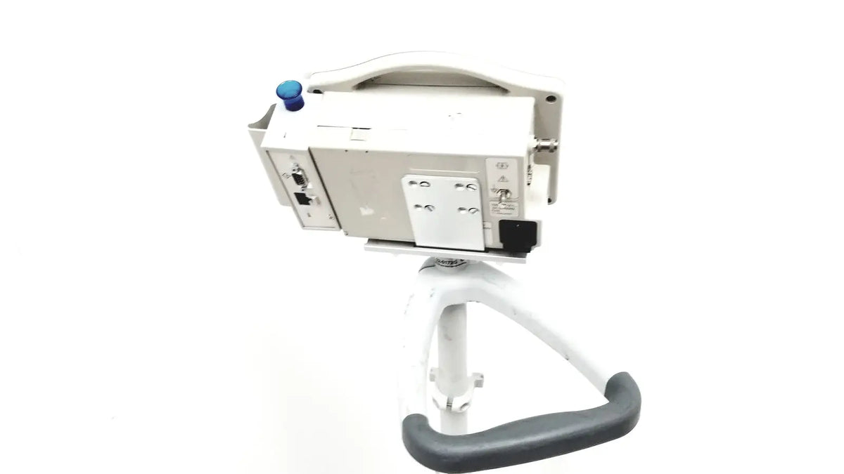White casmed 740 patient monitor spo2 mounted on adjustable stand with gray ergonomic handle for medical use