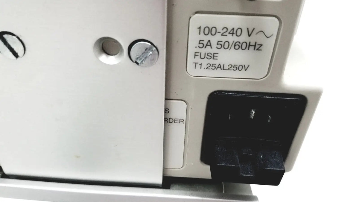 White electrical outlet with black plug labeled 100-240 v connected to casmed 740 patient monitor spo2 back side