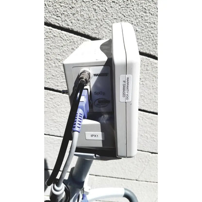 White plastic casmed 740 vital signs monitor with purple and black sp02 finger probe cable connected to port