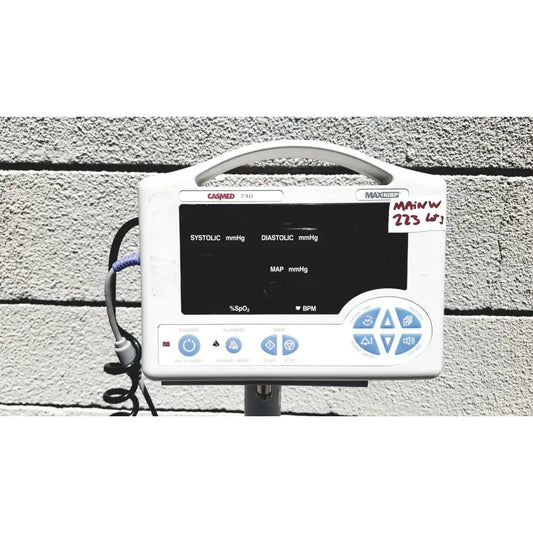 White casmed 740 vital signs monitor with sp02 finger probe black display and blue control buttons on rolling stand