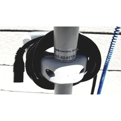 White cylindrical casmed 740 vital signs monitor with black coiled and blue spiral cables on rolling stand lot of 3
