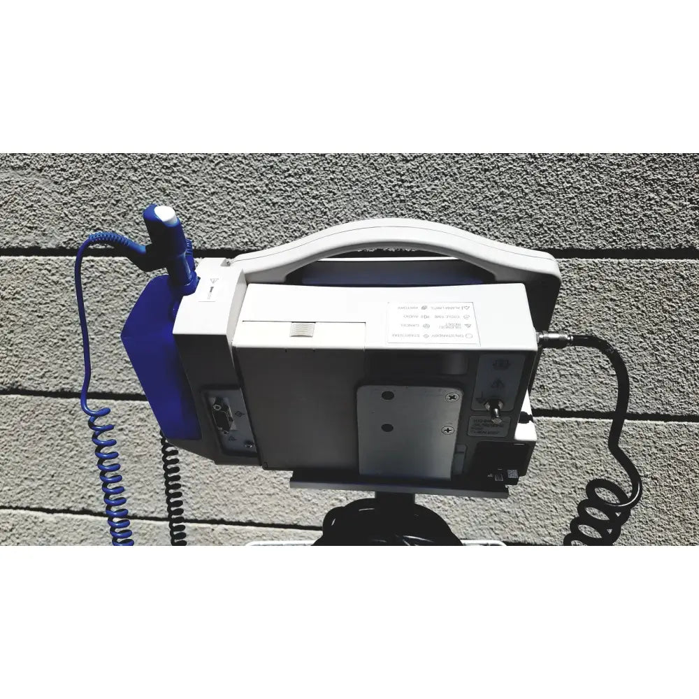 White and blue portable defibrillator with coiled cable for vital signs monitor casmed 740 with rolling stand lot of 3