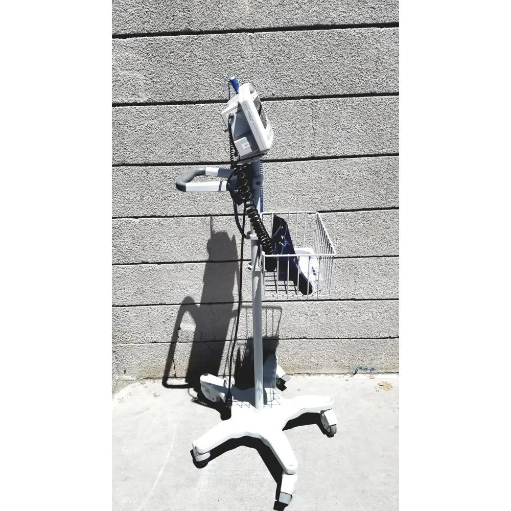 White medical cart with metal basket and wheels holding casmed 740 vital signs monitor for accurate vital signs monitoring
