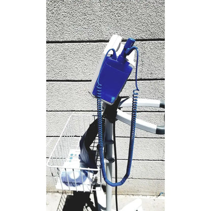 Blue and white casmed 740 vital signs monitor with coiled cord mounted on rolling stand for medical use