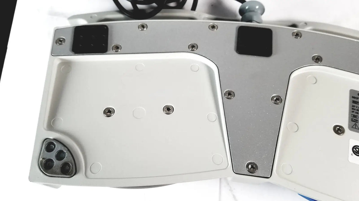 Silver and white ergonomic cellvizio foot pedal keyboard with black rubberized keycaps and metallic screws for reuse medical use