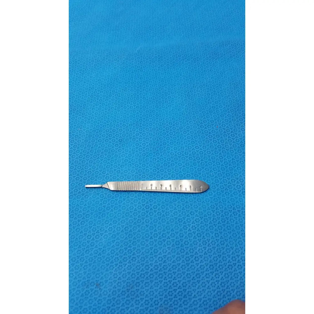 Silver centurion pakistan scalpel handle scale with textured grip and measurement markings on the blade for precision use