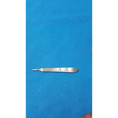 Silver centurion pakistan scalpel handle scale with textured grip and measurement markings on the blade for precision use