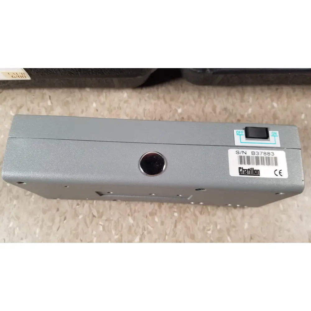 Gray metallic chaltilon csd200 dynamometer with black toggle switch and circular port on its back side