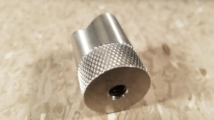 Silver metallic cylindrical adapter with knurled texture and centered threaded hole for chaltilon csd200 dynamometer reuse medical use