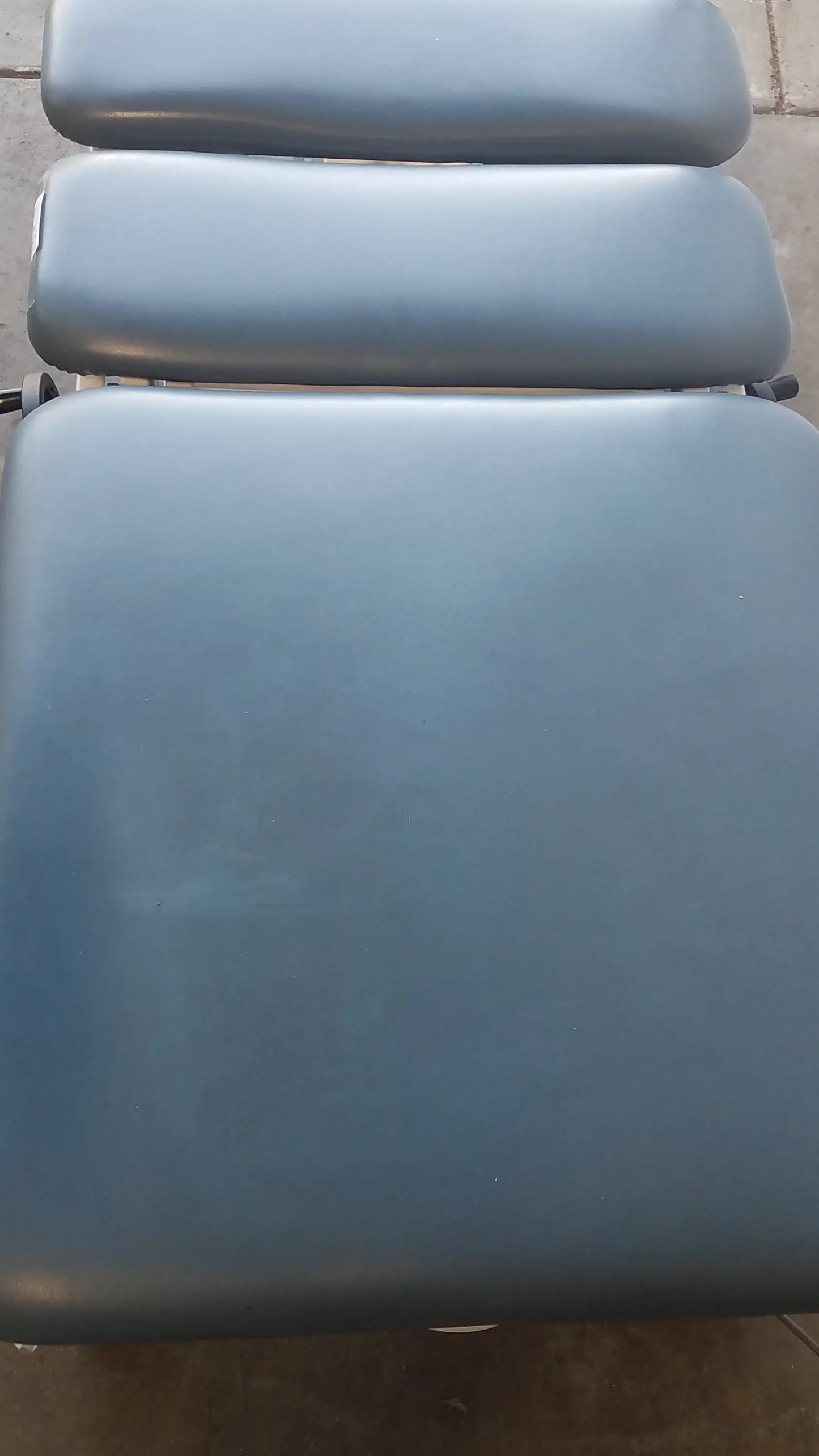Blue padded chattanooga triton dts table with three adjustable sections for physical therapy equipment use