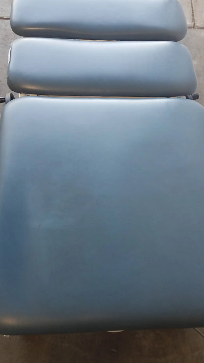 Blue padded chattanooga triton dts table with three adjustable sections for physical therapy equipment use