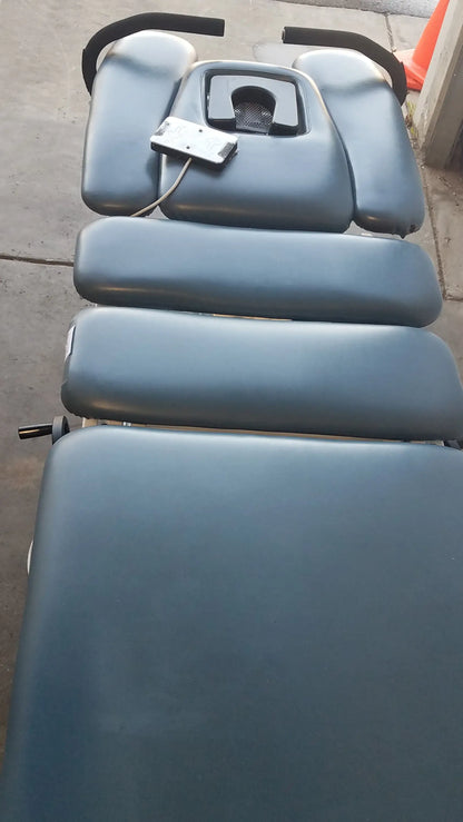 Blue padded Chattanooga Triton DTS traction table with black headrests and silver control unit for physical therapy equipment
