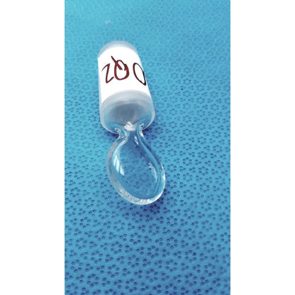 Clear glass chemglass high vacuum glass stopcock with white label marked 200 and teardrop-shaped dropper attached