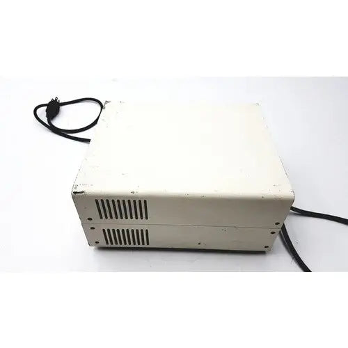 Off-white slightly worn chiu technical corporation mercury 100w power supply unit with black ventilation slits and coiled cord