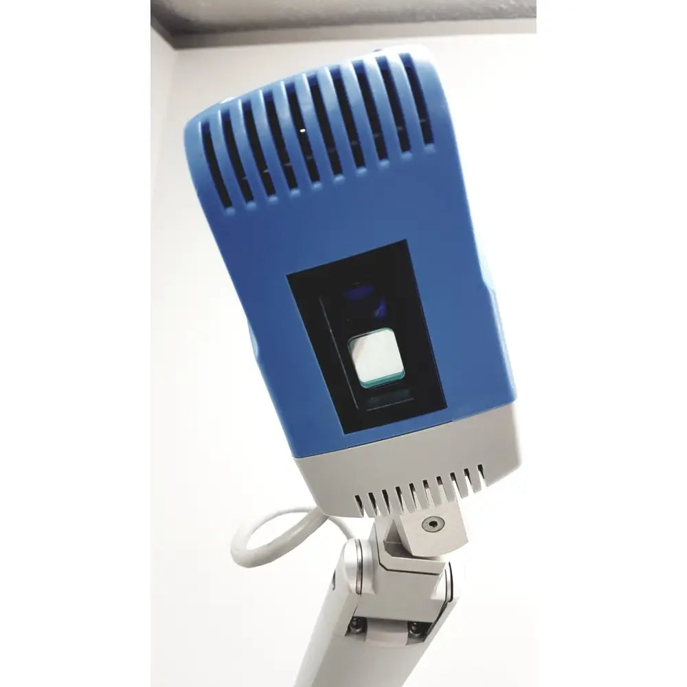 Blue and gray handheld scanner with rectangular lens housing for Christie VeinViewer Vision vein visualization system with stand