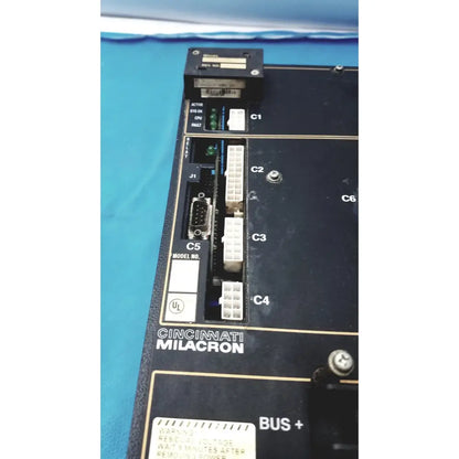 Black Cincinnati Milacron industrial control panel with white connectors and gold labeling for Milacron C5 spindle drive