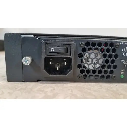 Black plastic back side of cisco 5500 series wireless lan controller model 5508 with hexagonal vent grille and ac input socket