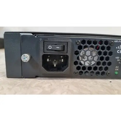 Black plastic back side of cisco 5500 series wireless lan controller model 5508 with hexagonal vent grille and ac input socket