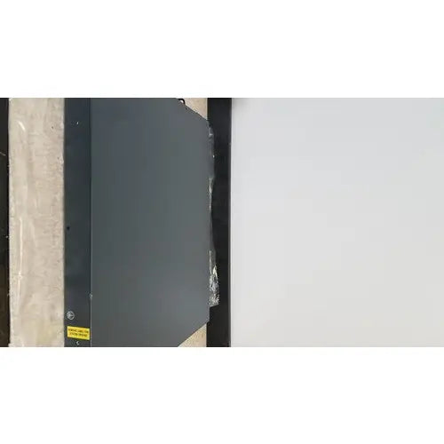 Dark gray metal cisco 5500 series wireless lan controller model 5508 with yellow warning label on lower left corner