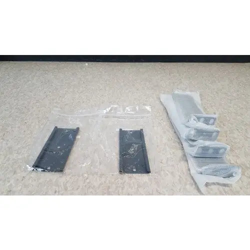 Black plastic mounting brackets in protective wrapping for Cisco 5500 series wireless lan controller model 5508