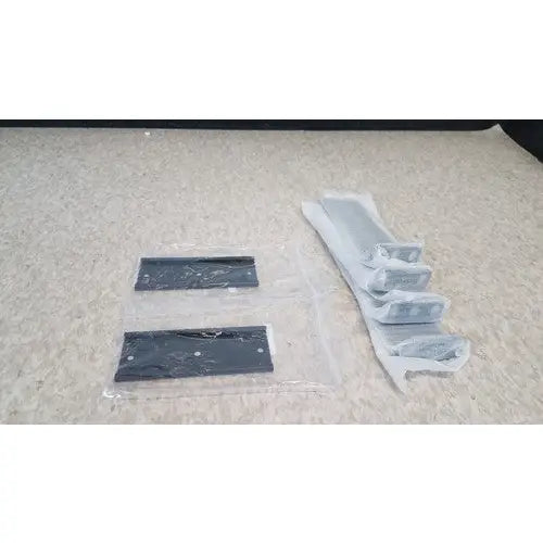 Black rectangular mounting plates and silver metal brackets in clear packaging for cisco 5500 series wireless lan controller model 5508