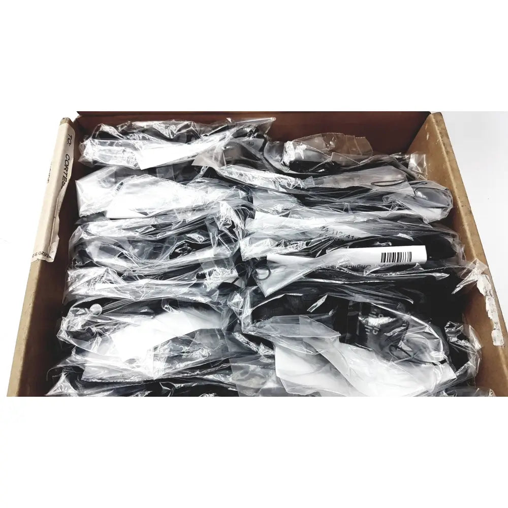 Black plastic safety goggles in clear packaging suitable for reuse medical and office desk accessories use