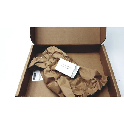 A white rectangular cisco cp-batt-7925g-ext wireless ip phone accu battery inside a brown cardboard shipping container wrapped in paper