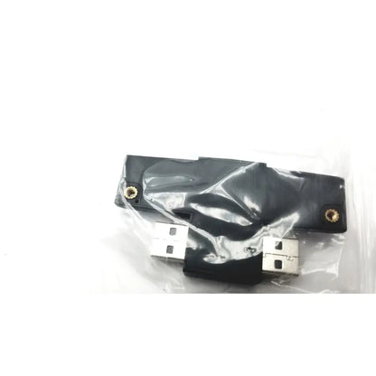 Black plastic cisco ip phone key expansion module with gold screw holes and two silver usb connectors attached