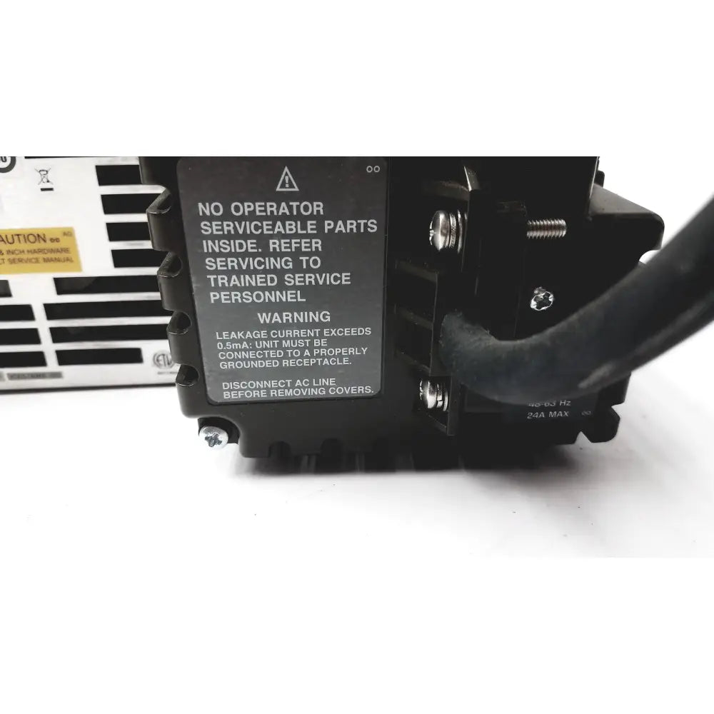 Black plastic Cisco WAE 600 Series wide area application engine power supply with warning label and screw fastenings