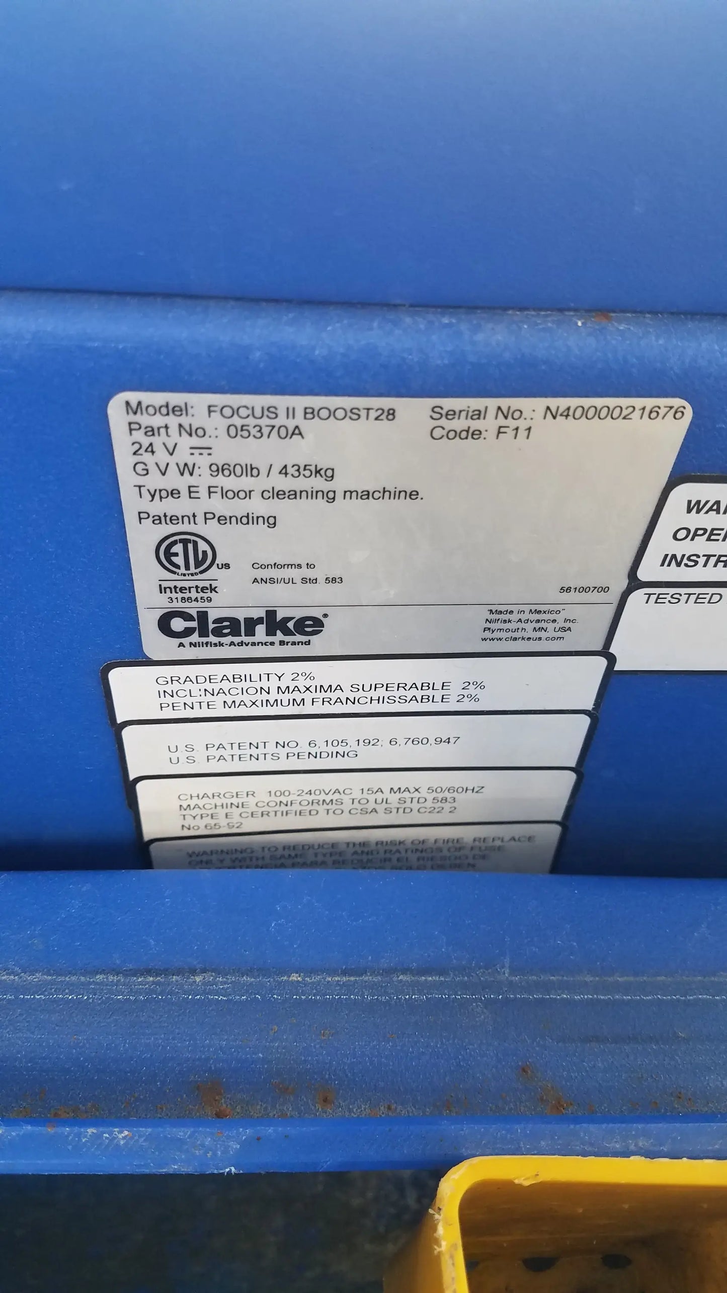 Blue clarke focus ii boost 28 floor scrubber with white label showing specifications and safety certifications