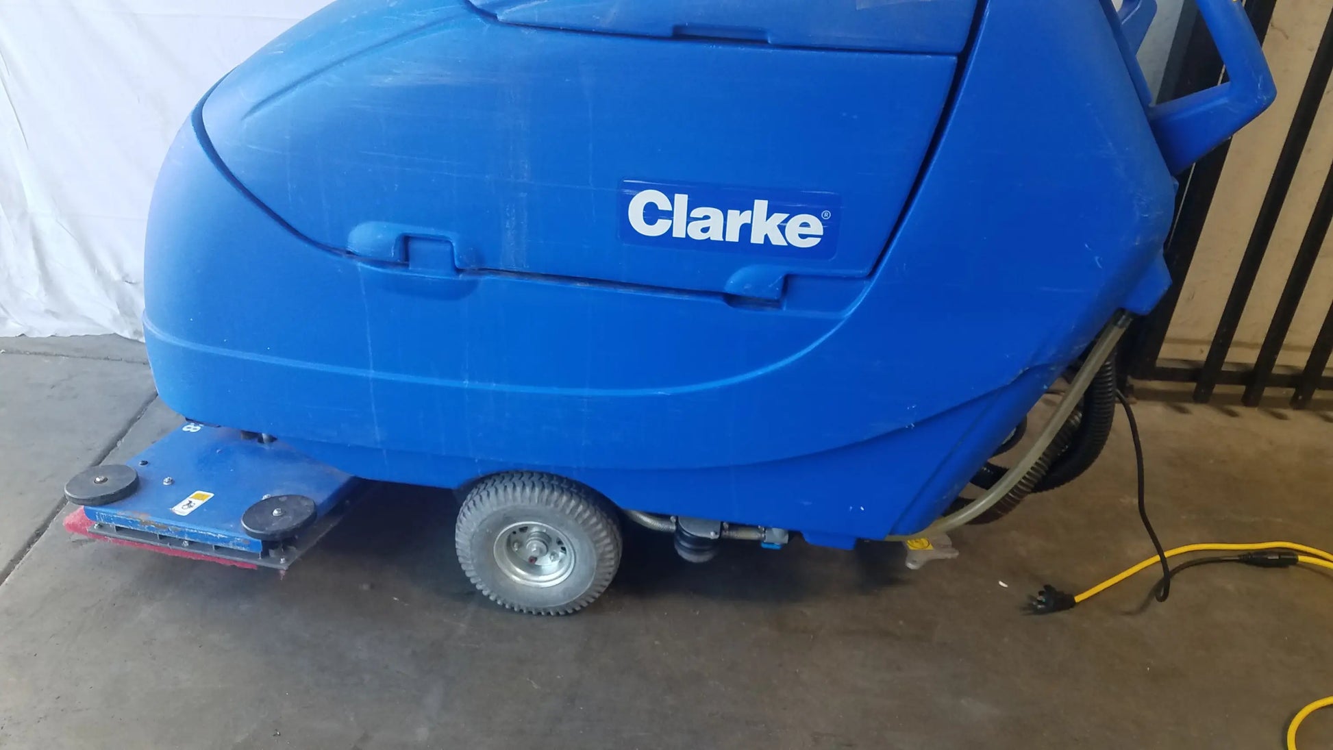 Blue Clarke focus ii boost floor scrubber with rounded plastic body and small wheels for efficient floor cleaning machine use