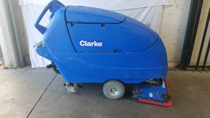 Blue Clarke focus ii boost 28 floor scrubber with red cleaning head and black wheels for efficient floor cleaning machine use