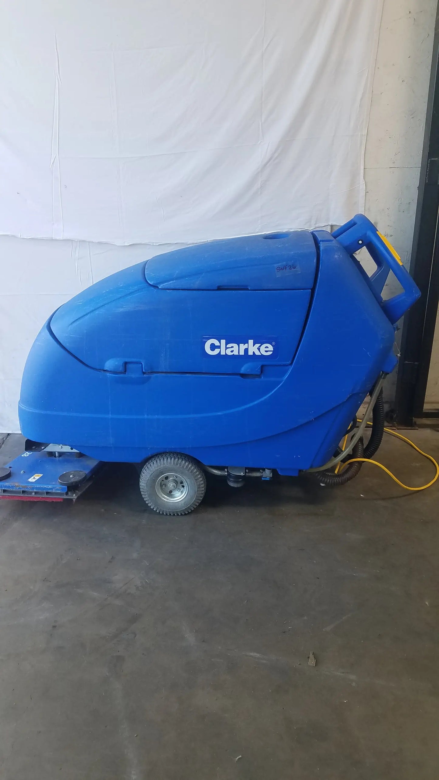 Blue clarke focus ii boost 28 floor scrubber with rounded enclosed body and visible wheels for floor cleaning