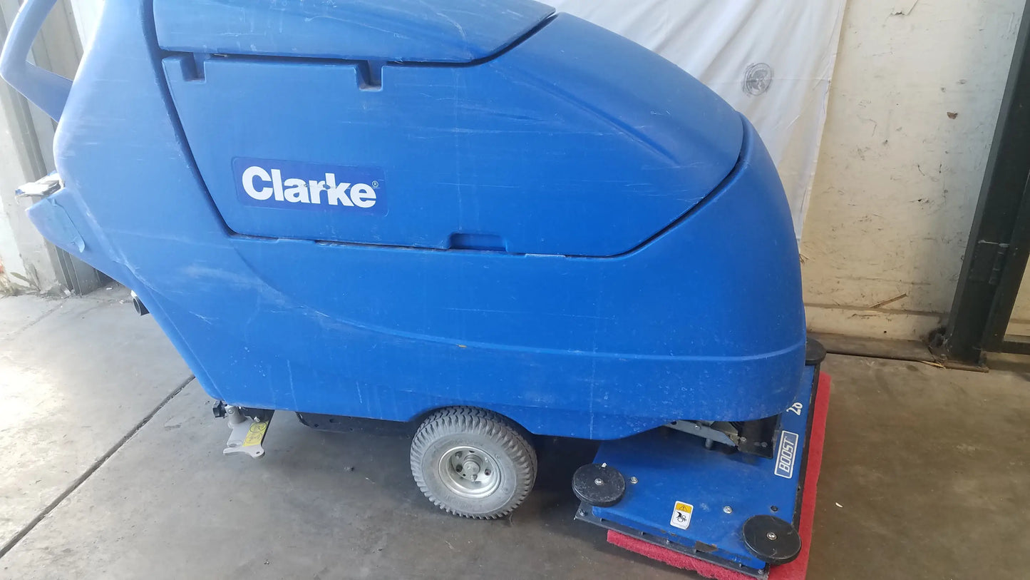 Clarke focus II boost floor scrubber with blue body, red cleaning head, and black wheels for commercial floor cleaning