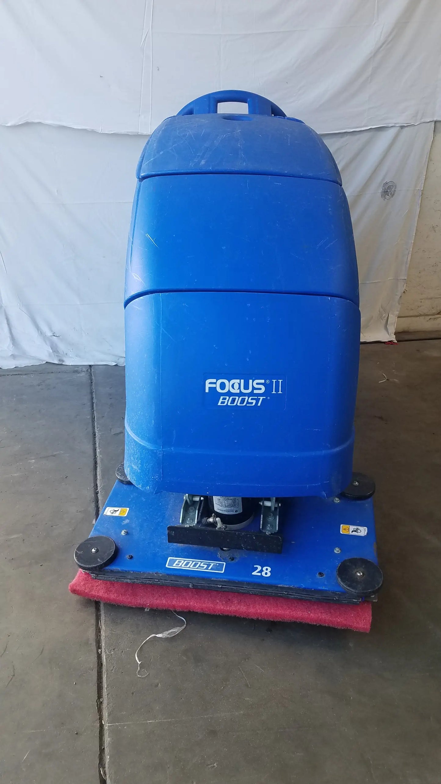 Clarke focus ii boost floor scrubber in blue plastic with red brush and black wheels for efficient floor cleaning