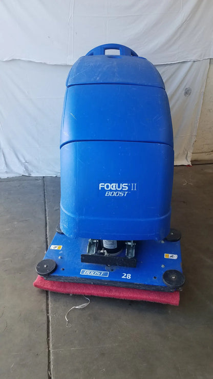 Clarke focus ii boost floor scrubber in blue plastic with red brush and black wheels for efficient floor cleaning