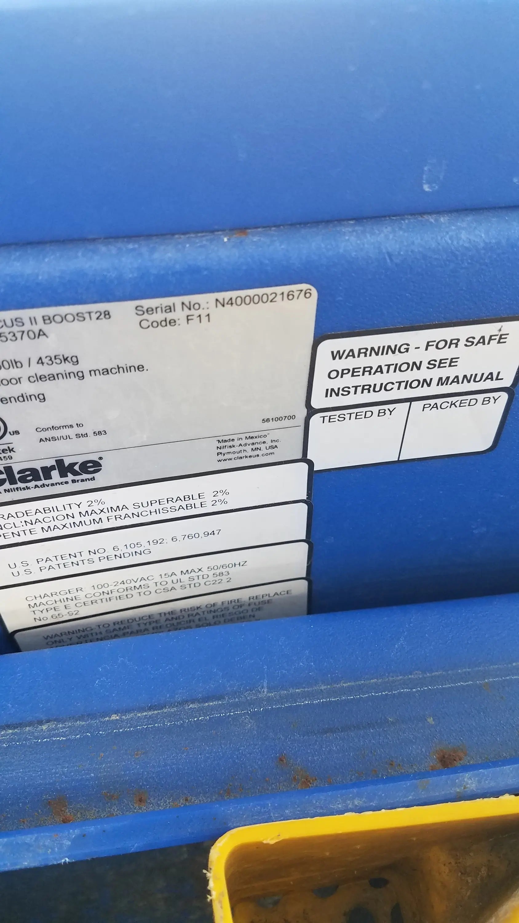Blue clarke focus ii boost 28 floor scrubber back view with serial number and warning label for floor cleaning machine