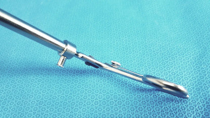 Shiny metallic claw gasper 10mm surgical instrument with long slender handle and articulated joint for precise use