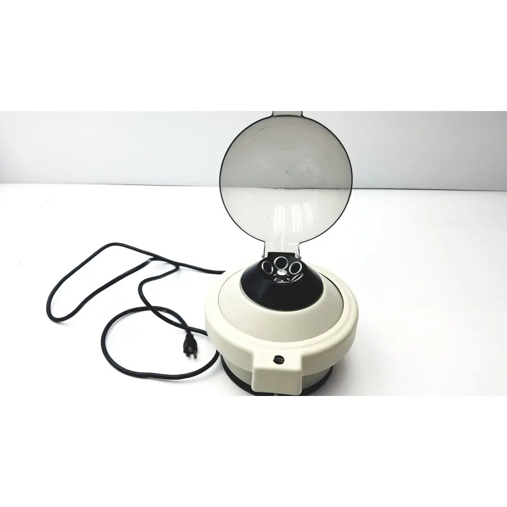 Cream-colored clay adams roche model 0171 analytical centrifuge with transparent dome lid and black rotor chamber
