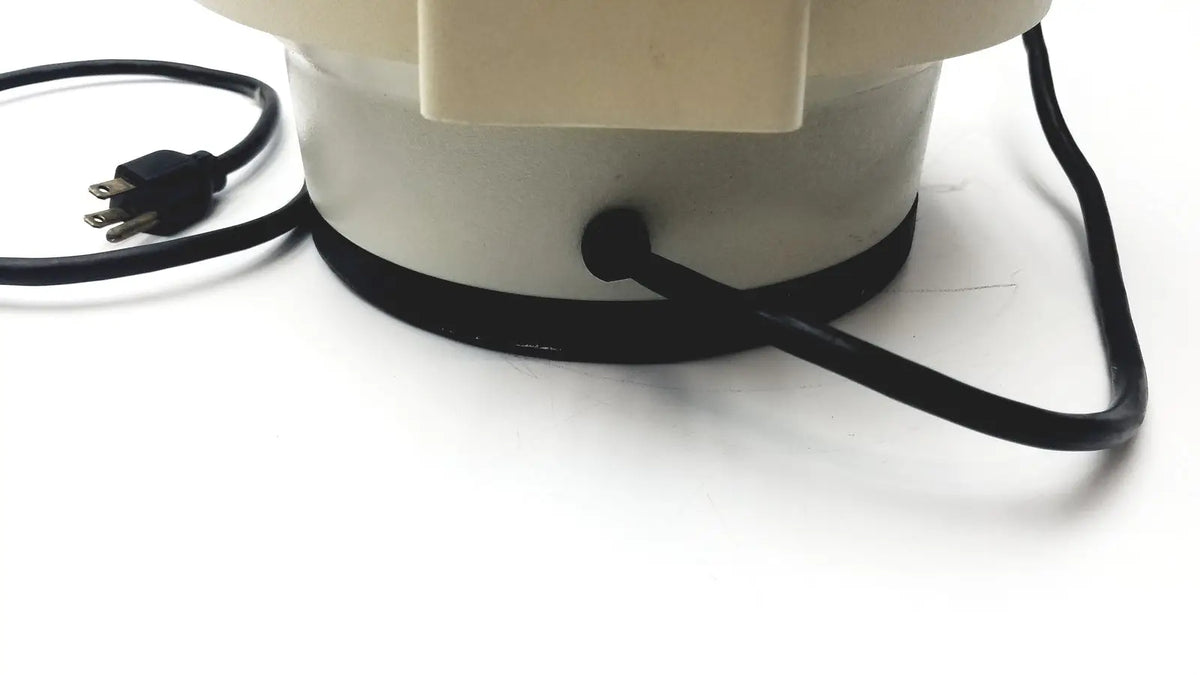Cream-colored cylindrical fan base with black power cord and plug of clay adams roche model 0171 analytical centrifuge