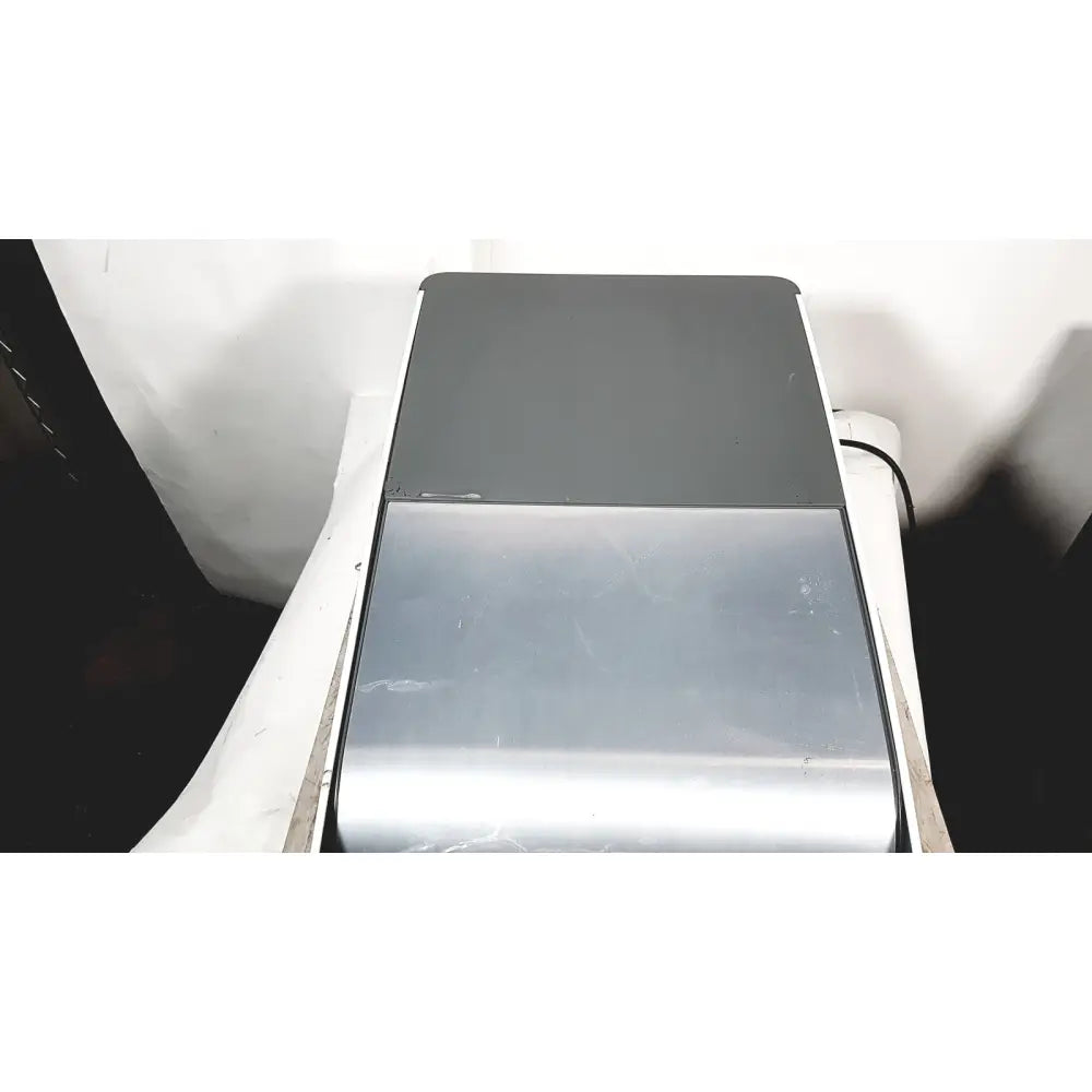 Silver and black dual tone laptop shown with cleanSlate uv csuv-ug6cx mobile device sterilizer system for device hygiene