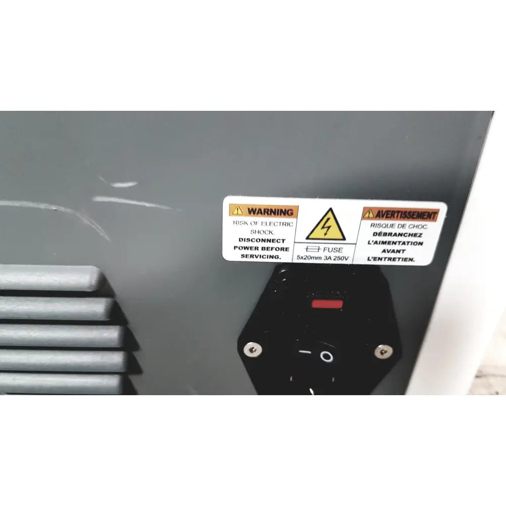 Black power switch with red indicator and silver screws on gray panel of cleanSlate UV csuv-ug6cx mobile device sterilizer