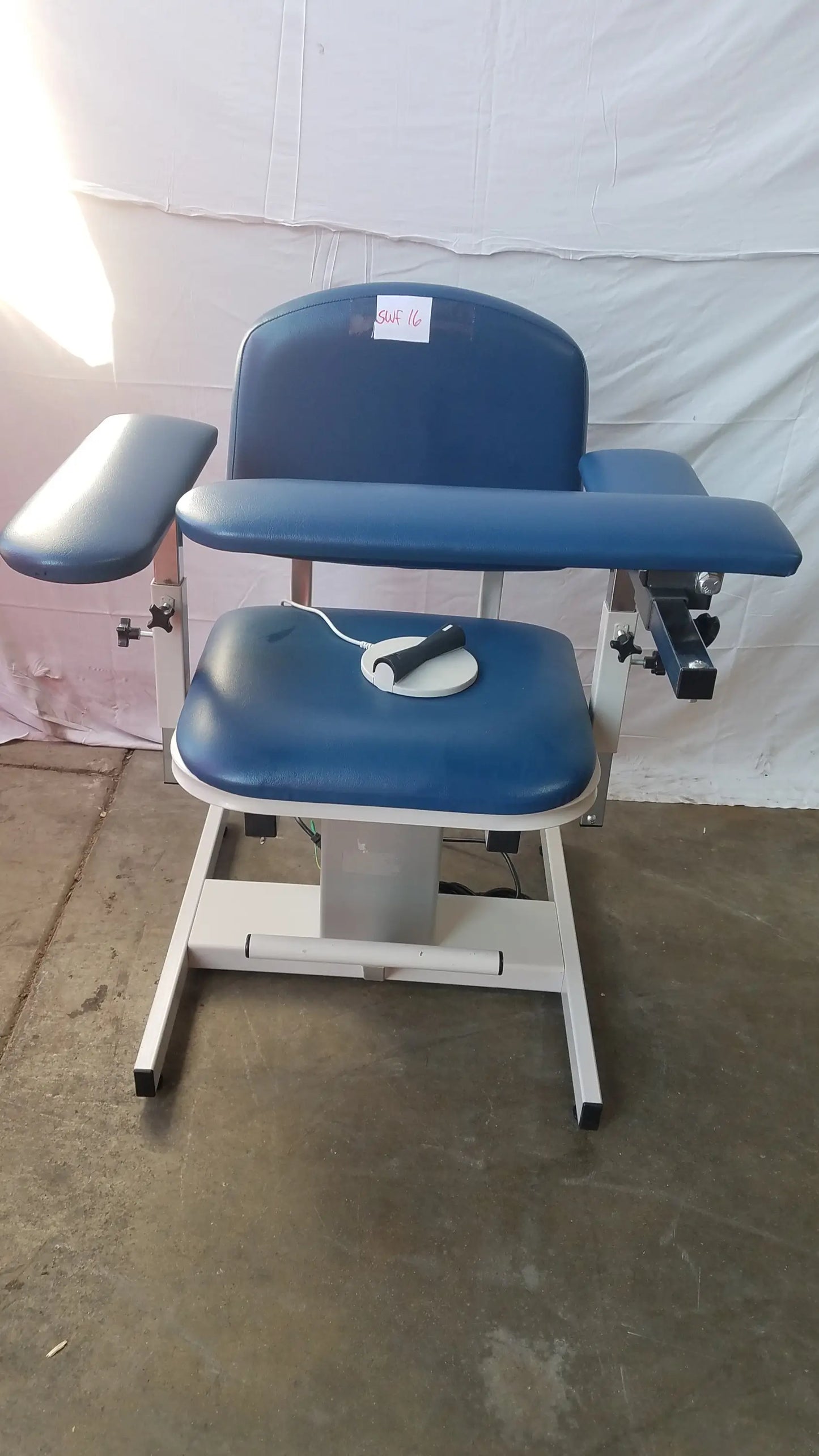 Blue padded clinton 6341 power series blood drawing chair with adjustable armrests and white metal frame