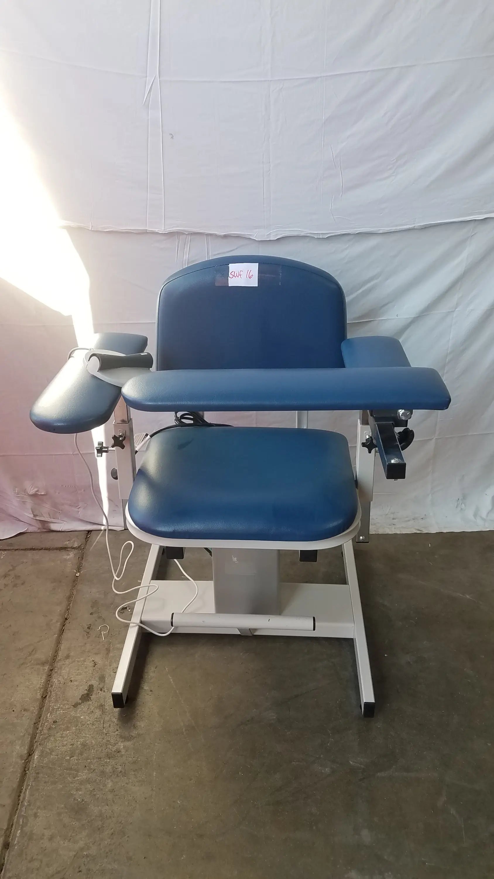 Blue padded clinton 6341 power series blood drawing chair with adjustable armrests and white metal frame