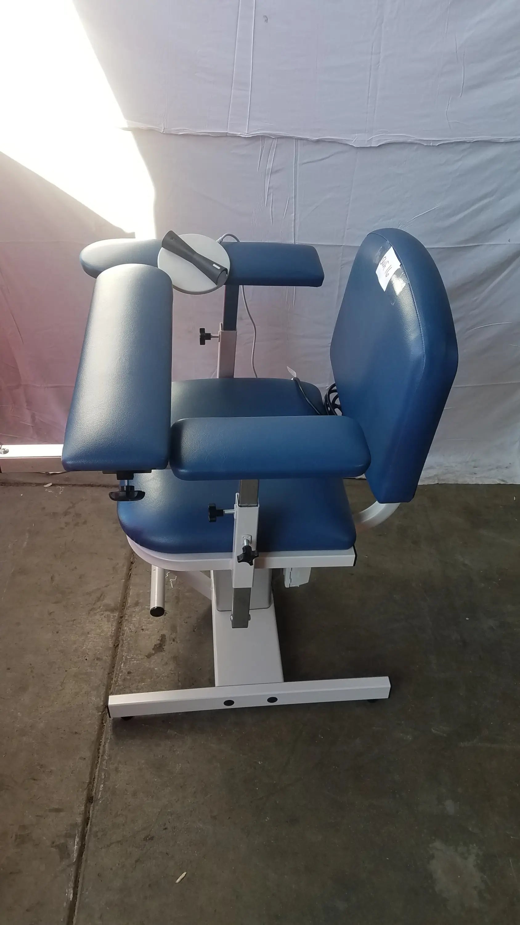 Blue padded Clinton 6341 power series blood drawing chair with adjustable armrests and white metal frame