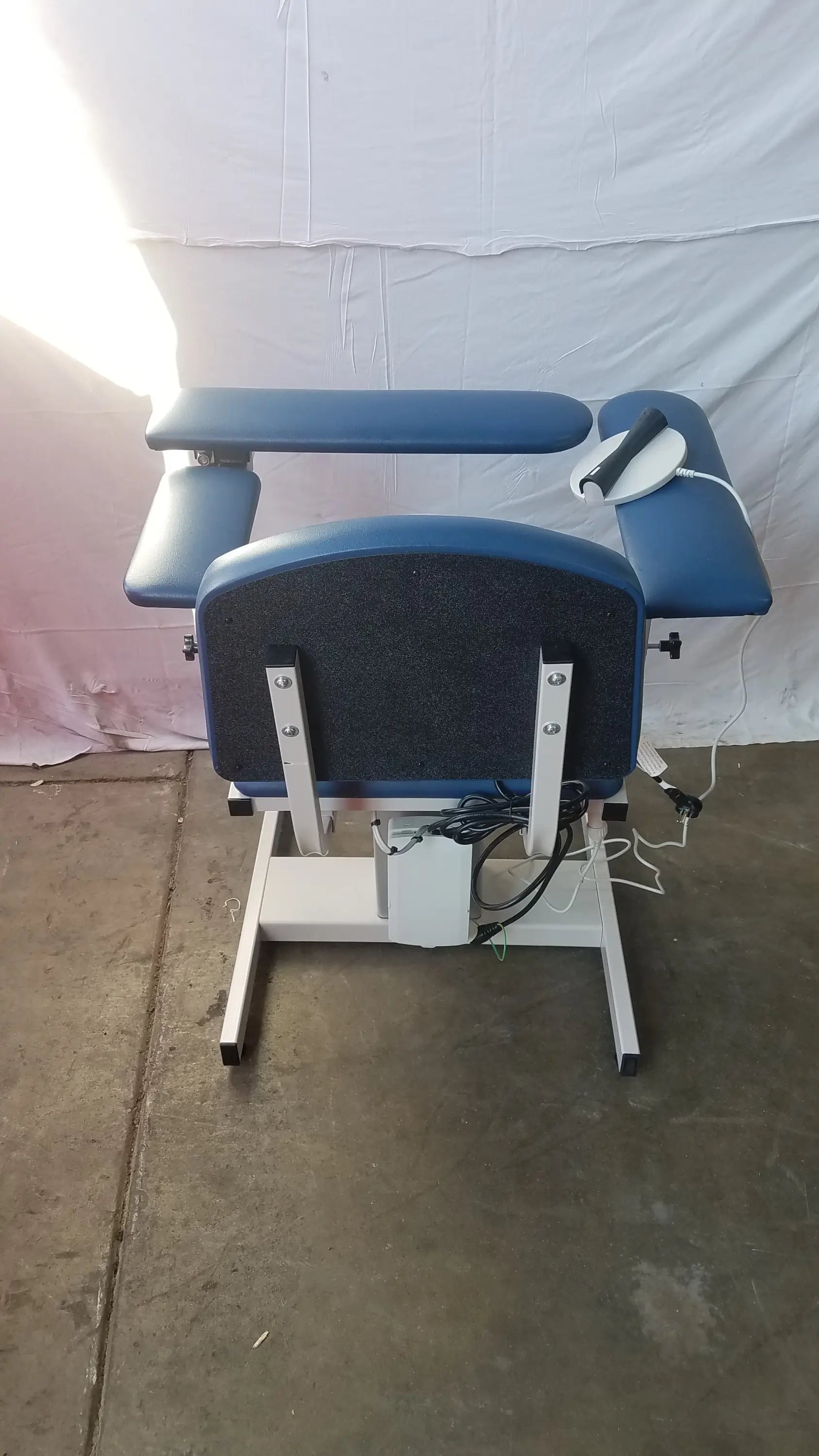 Blue padded clinton 6341 power series blood drawing chair with white metal frame and adjustable armrests for blood drawing
