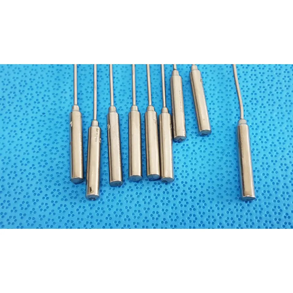 Set of metallic cylindrical temperature sensors with threaded ends engraved markings in codman debakey mall surgical instrument set